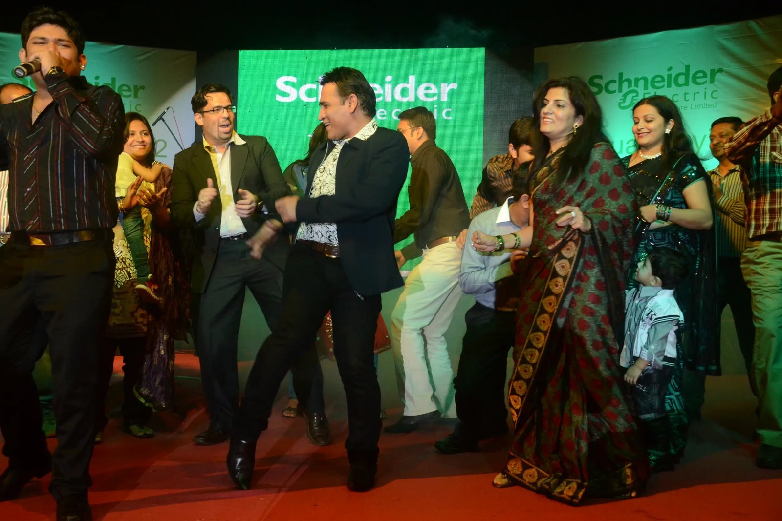 Festival Celebrations with people dancing on stage and colorful lighting